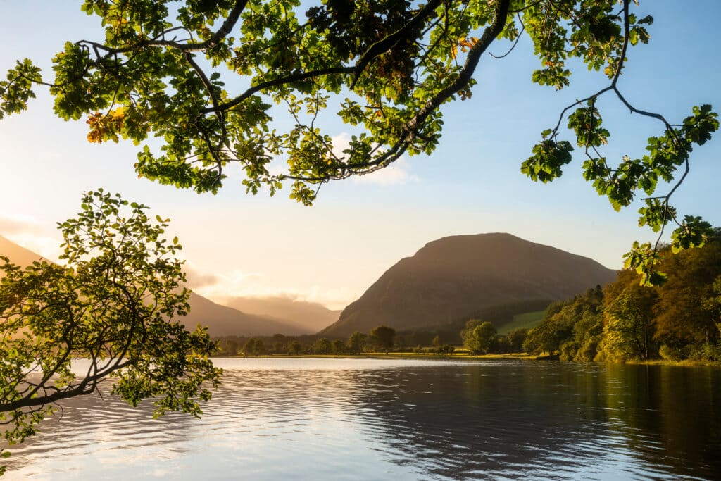 Lovely sunrise landscape image looking along Loweswater towards wonderful light on Grasmoor and Mellbreak mountains in Lake District