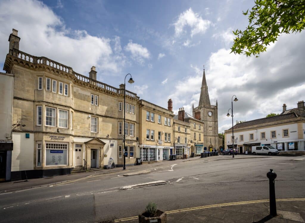 Market Place, Chippenham with spire and clock tower of St Andrew's church in Chippenham, Wiltshire, UK