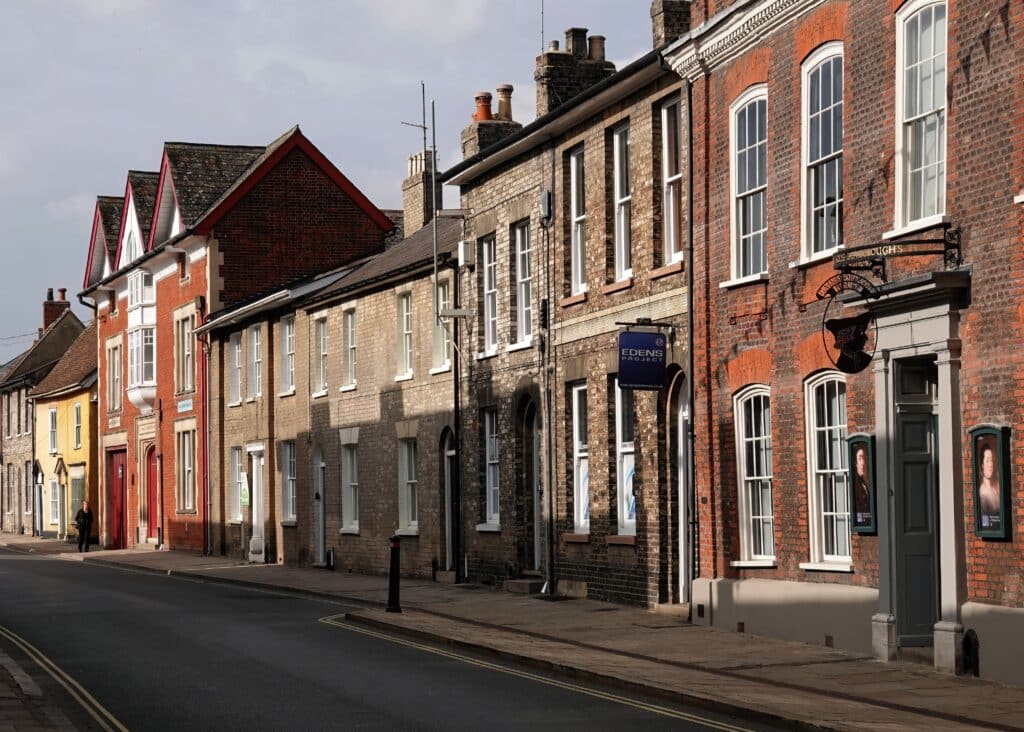 A street scene featuring Gainsborough House, a museum dedicated to the artist Thomas Gainsborough, and neighbouring historic properties in Sudbury, Suffolk, UK