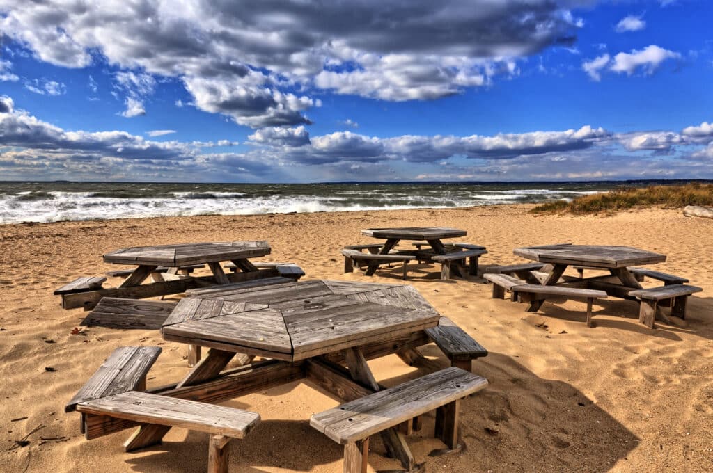 Hammonasset Beach picnic tables on a windy day with bright sunshine