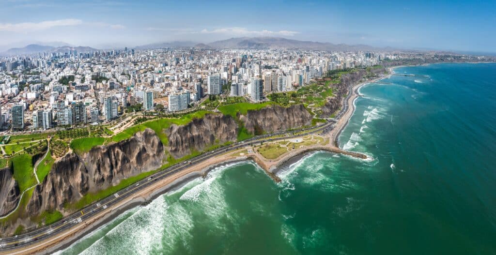 LIMA, PERU: Aerial view of Miraflores town, cliff and the Costa Verde high way