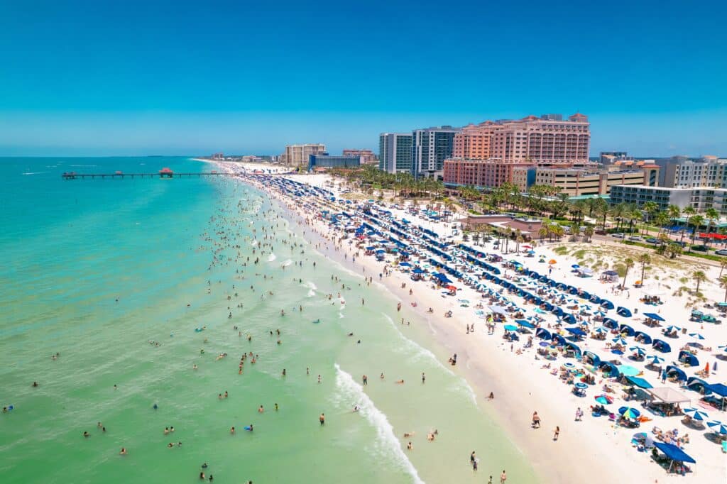 Beach. Panorama of Clearwater Beach FL. Florida Beaches. Summer vacations. Beautiful View on Hotels and Resorts on Island. Turquoise color of Ocean water. American shore Gulf of Mexico. Sunny Day
