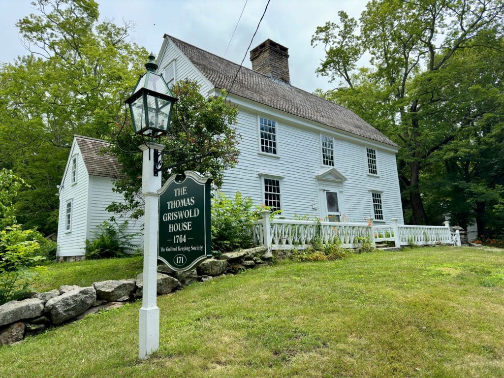 Guilford, Connecticut, USA: The Thomas Griswold House during summer. Built in 1764. Sign post in front.