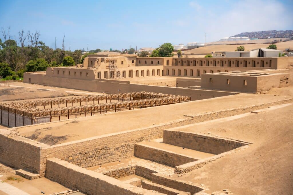 A view of the ancient ruins at Pachacamac, Peru, showcasing historical architecture and archaeological significance under a clear blue sky.