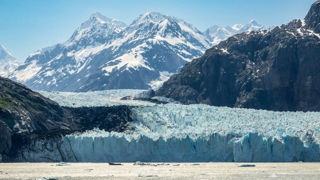 Tidewater terminus of Margerie Glacier, a World Heritage site, the largest glacier in Glacier Bay National Park and Preserve, with a view of mountains in the area, mid afternoon in southeastern Alaska
