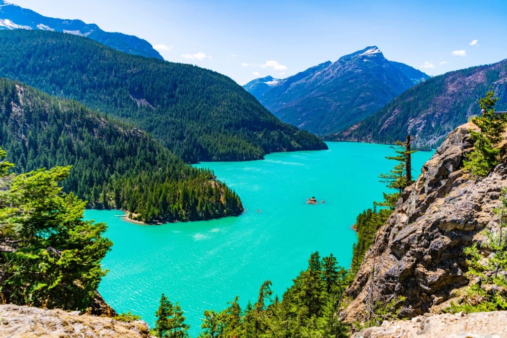 Landscape of mountain peak and Diablo lake. Nature landscape. Diablo Lake in North Cascades National Park. Scenic nature view over lake. Diablo lake with mountain landscape. Diablo wilderness