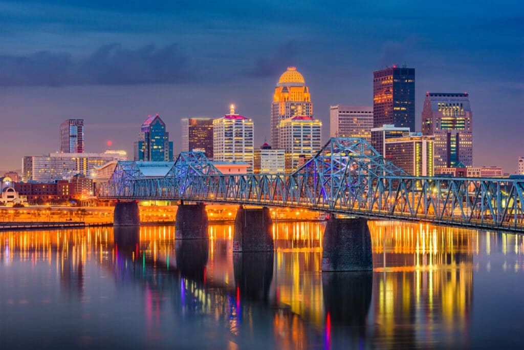 Louisville, Kentucky, USA downtown skyline on the Ohio River at dusk.