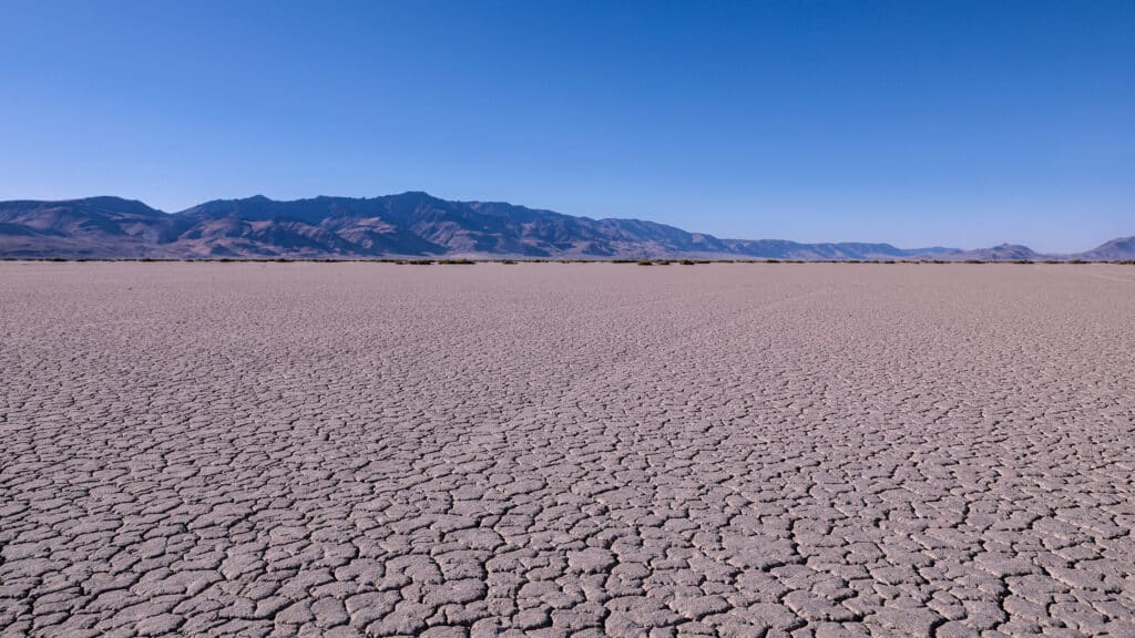 Panoramic view at Alvord desert with Steens mountains in the background. View of cracked Alvord Lake playa.