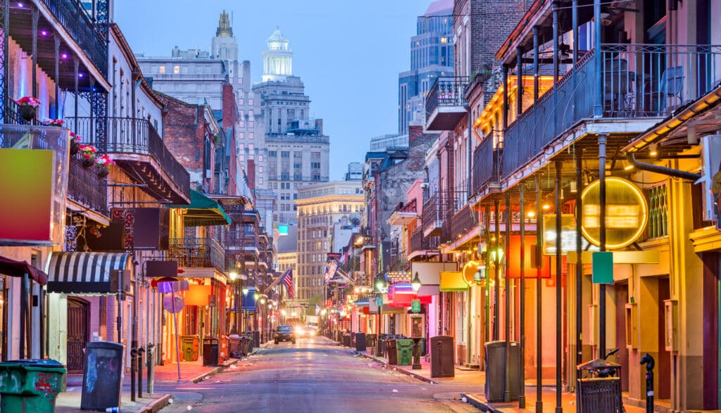Bourbon St, New Orleans, Louisiana, USA cityscape of bars and restaurants at twilight.
