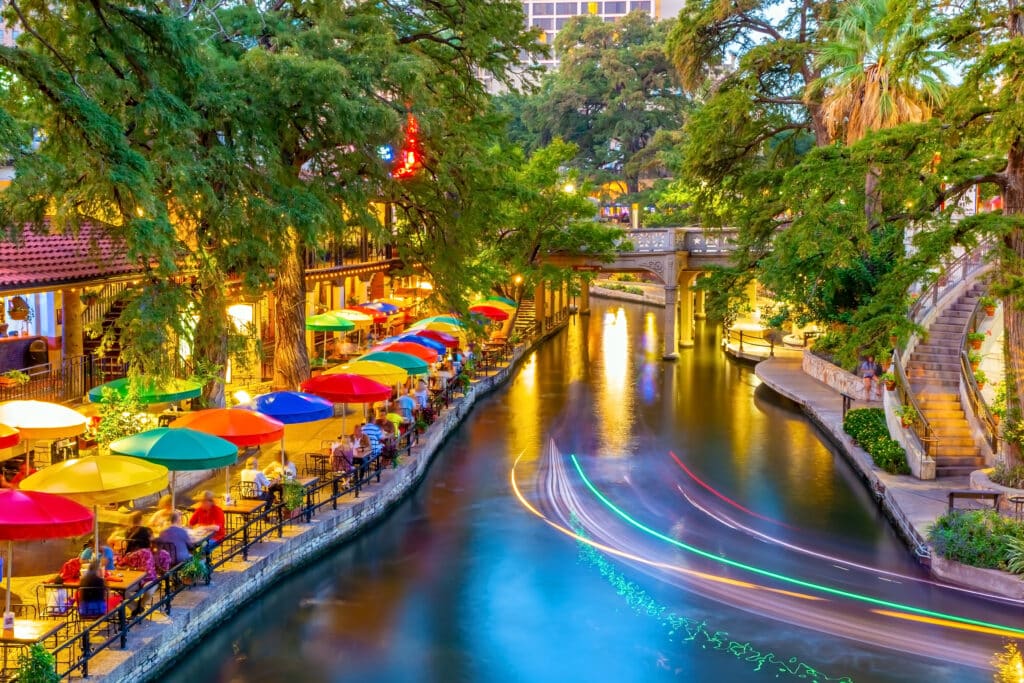 River walk in San Antonio city downtown skyline cityscape of Texas USA at sunset