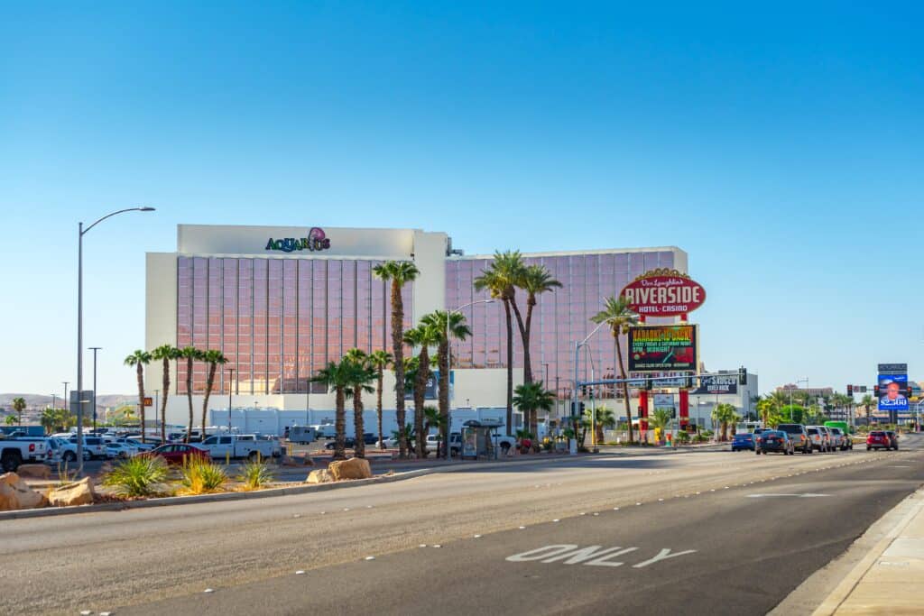 Street view of Aquarius Resort building and the Riverside Hotel and Casino sign on Casino Drive in Laughlin, Nevada.