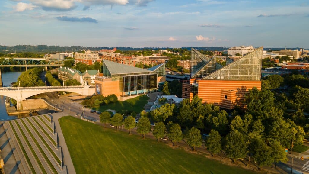 Captured from above, the Tennessee Aquarium in Chattanooga stands out with its modern design, surrounded by lush gardens and the flowing Tennessee River.