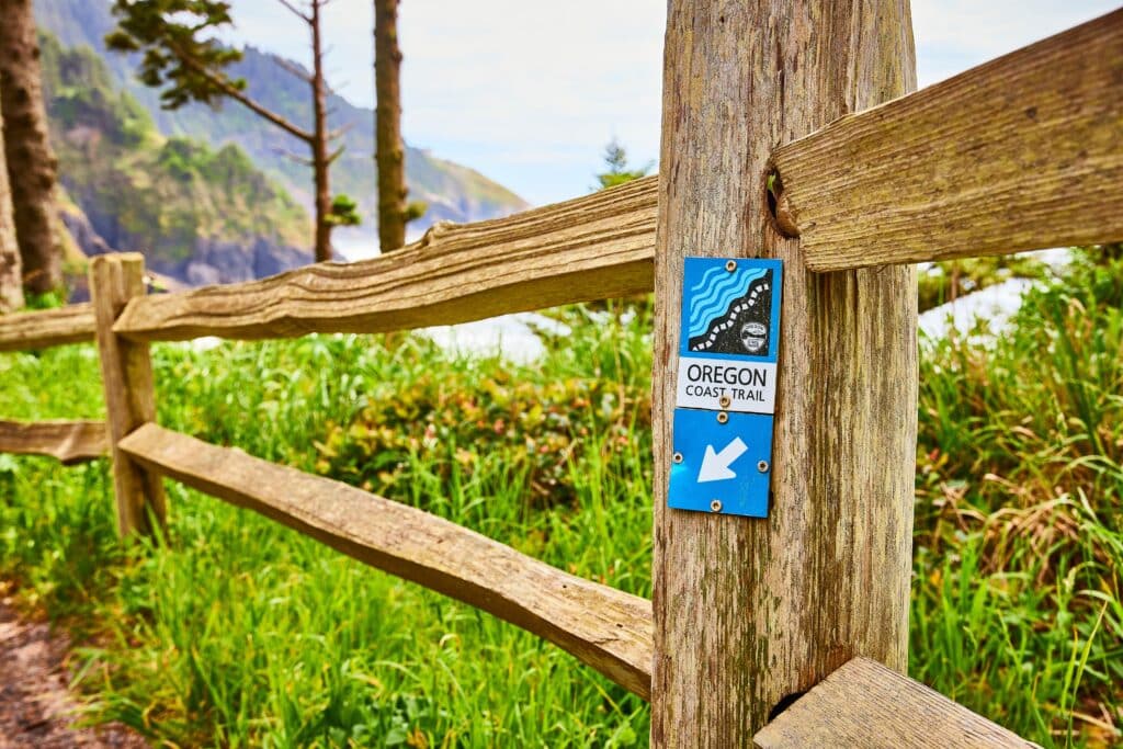 Oregon Coast Trail Sign with Ocean View from Trailhead Perspective