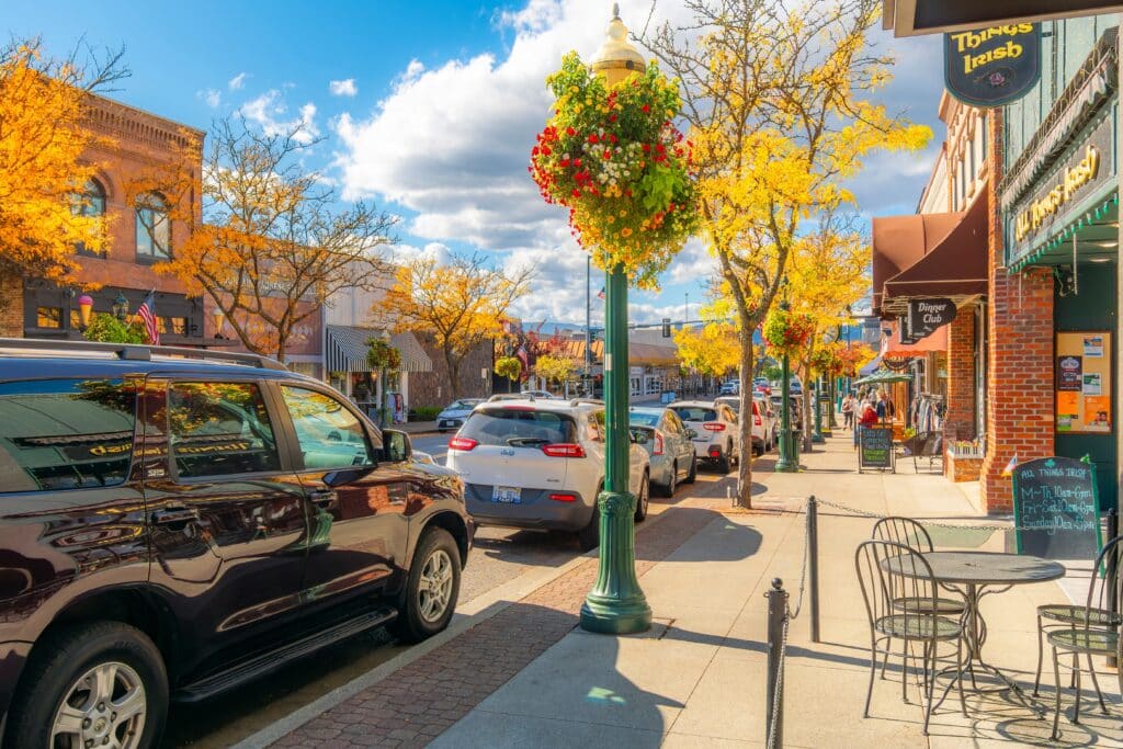 Shops and sidewalk cafes on Sherman Avenue in the lakeside small town of Coeur d'Alene, Idaho at autumn in the North Idaho panhandle region