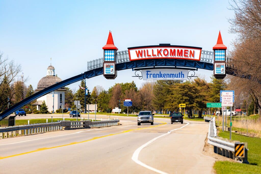 Photo of Frankenmuth Michigan town entrance arch with Willkommen sign and tower structures welcoming visitors in Bavarian style