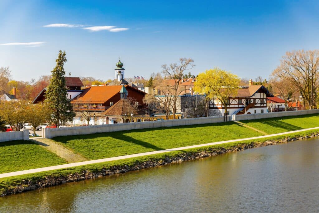 Aerial photo of Frankenmuth Michigan showing the river, buildings, and Bavarian-style charm on a bright sunny day.
