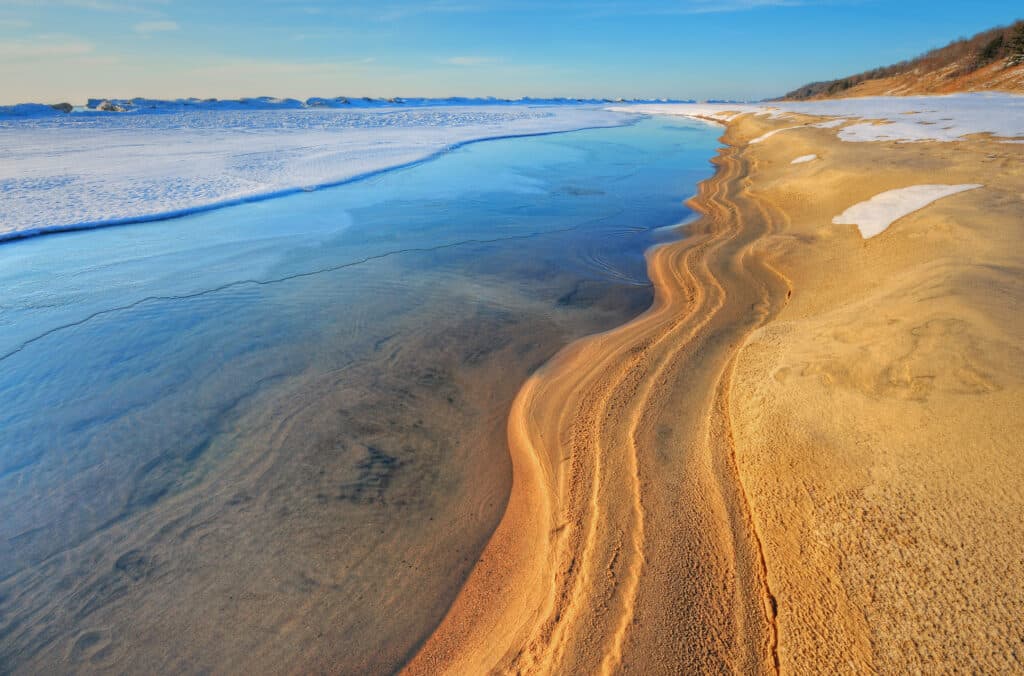 Iced shoreline of Lake Michigan near sunset, Saugatuck Dunes State Park, Michigan, USA