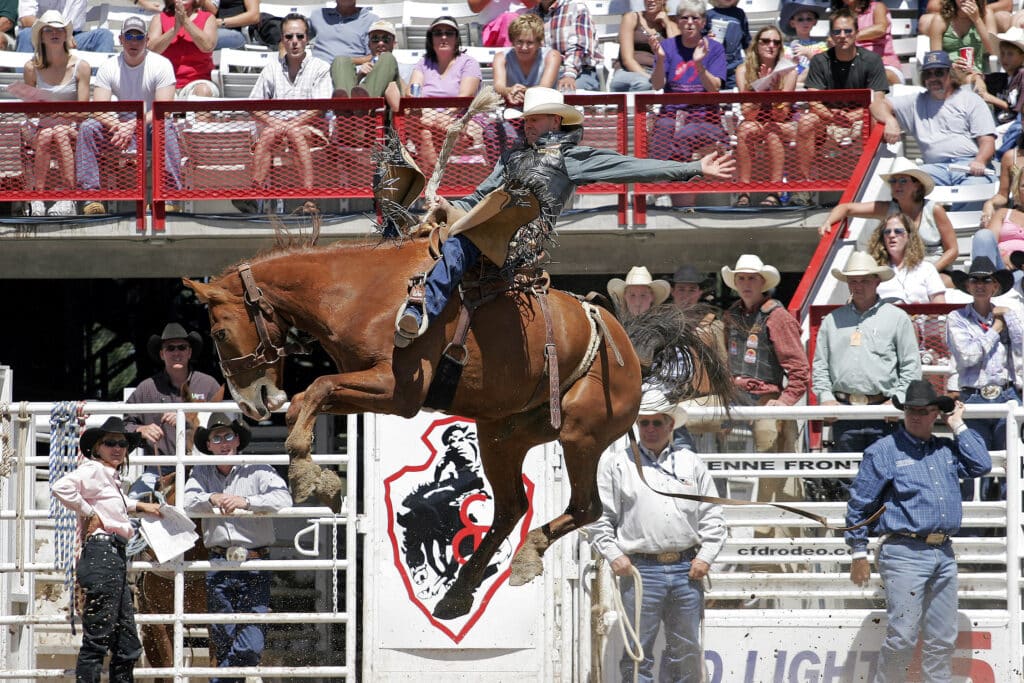 Multiple World Champion Saddle Bronc rider, Dan Mortensen, makes a successful ride at the 2005 Cheyenne Frontier Days rodeo.