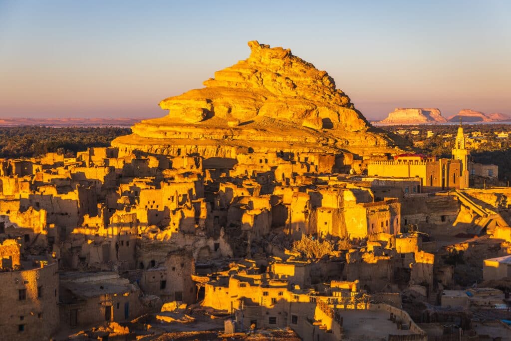 The Siwa Oasis is an urban oasis in Egypt between the Qattara Depression and the Great Sand Sea in the Western Desert, 50 km (30 mi) east of the Libyan border, and 560 km (348 mi) from Cairo.