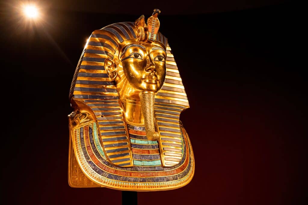 Cairo, Egypt. Glided funerary mask of king Tutankhamen. Tutankhamun famous pharaoh in Egypt. Tomb, symbol of ancient history. Exhibition in museum. High quality