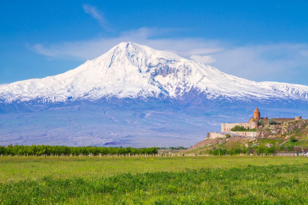 Awe-Inspiring medieval Khor Virap monastery in front of Mount Ararat viewed from Yerevan, Armenia. This snow-capped dormant compound volcano described in the Bible as the resting place of Noah's Ark.