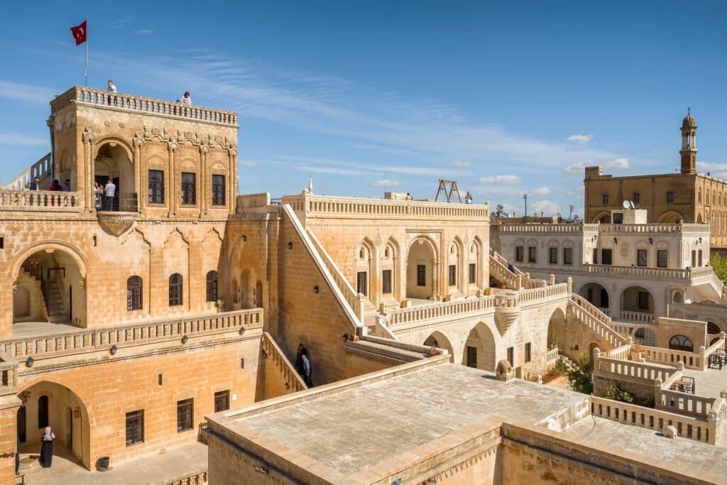 Midyat, Turkey: Famous Midyat Guest House in Midyat city, Mardin province, Turkey. Traditional architecture of the Midyat Konuk Evi building at sunny day.