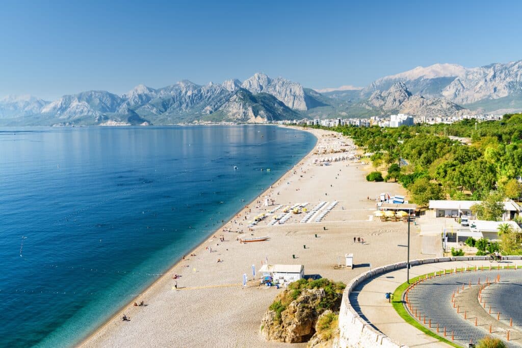 Awesome view of Konyaalti Beach and Park in Antalya, Turkey. Drone flying over the beach. Konyaalti Beach is a popular tourist attraction in Turkey.