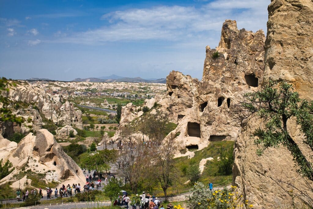 Nevşehir, Ürgüp, Turkey - International tourists visiting the historic rock-cut churches and cave dwellings at Göreme Open Air Museum, a UNESCO World Heritage site in Cappadocia, Turkey.
