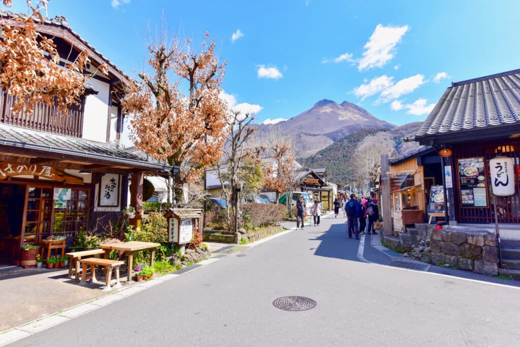 Traditional street in Yufuin with Mount Yufu rising in the background