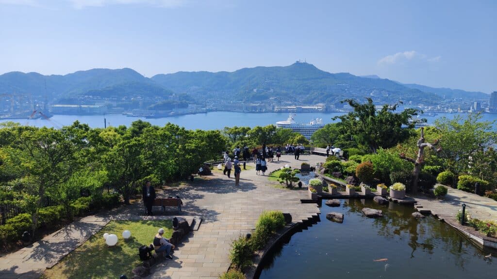 Visitors enjoying harbor views from Glover Garden in Nagasaki