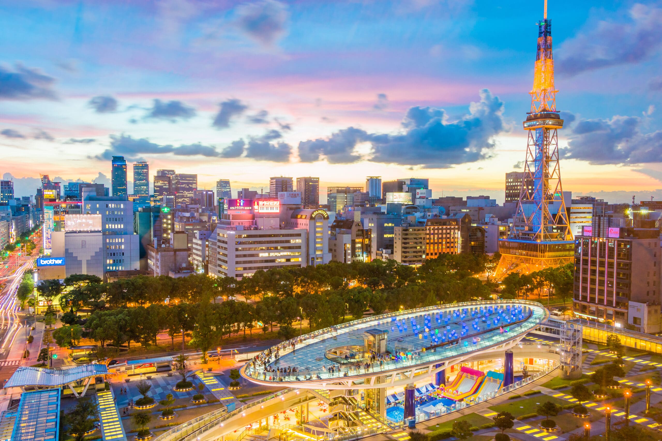 Oasis 21 and Nagoya TV Tower illuminated at sunset in the Sakae district