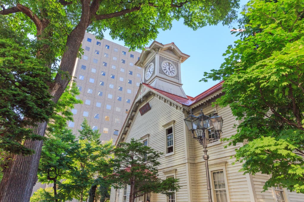 Historic Sapporo Clock Tower surrounded by green trees in central Sapporo
