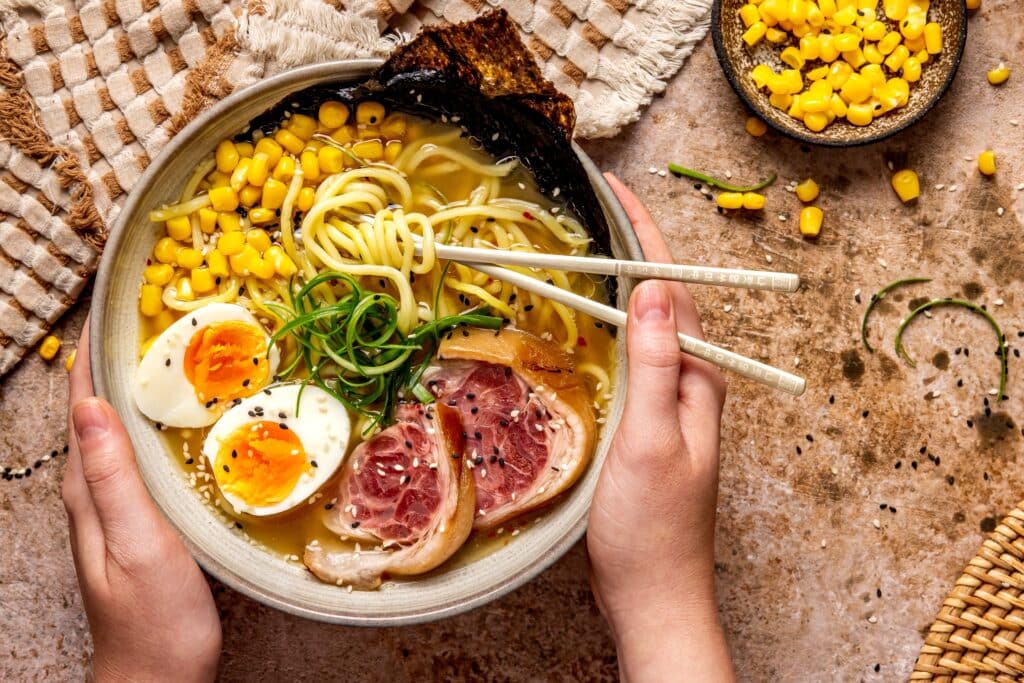 Bowl of Sapporo-style ramen topped with corn, egg, pork, and noodles