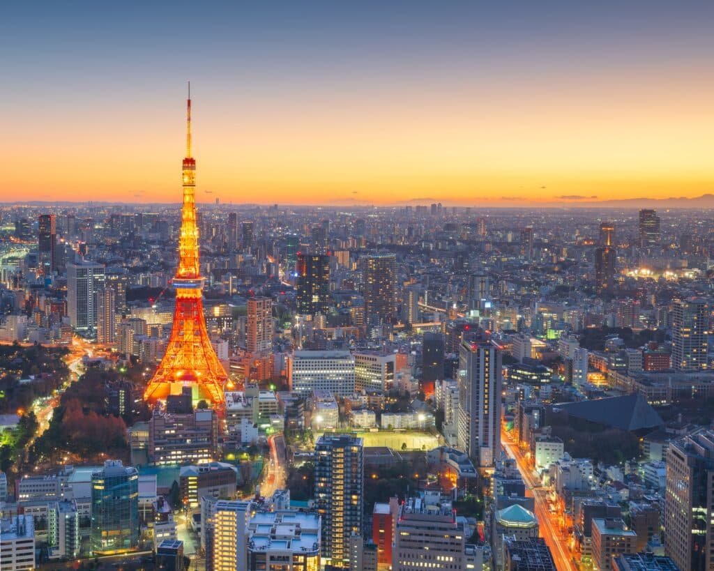 Tokyo Tower illuminated at sunset above the city skyline