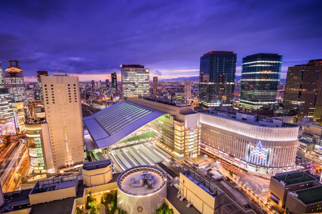Osaka Station surrounded by the modern Umeda skyline at dusk