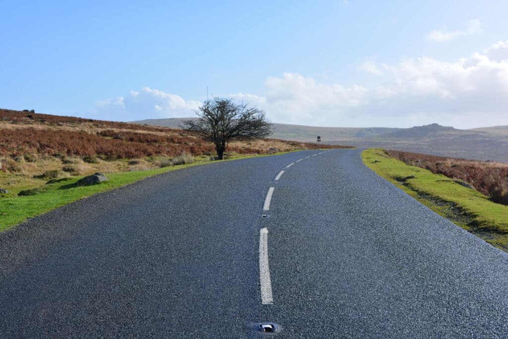 Scenic road crossing the open moorland of Dartmoor National Park in Devon